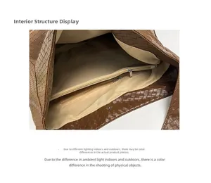Detail view of the brown woven tote interior with a zipper pocket and magnetic closure