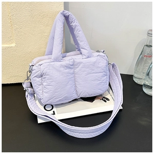 Detail of lavender quilted puffer tote bag with cylindrical handles and wide shoulder strap