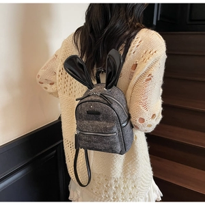 Mini dark grey tweed backpack featuring black leather bunny ears and silver zippers