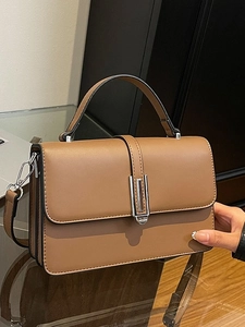 Brown leather crossbody square handbag with silver metal buckle and top handle
