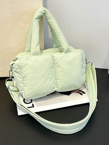 Pistachio green quilted puffer tote bag with puffy padded handles and crossbody strap