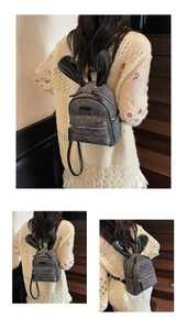 Close-up of mini grey wool backpack featuring cute black leather rabbit ears and silver zippers