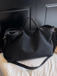 Large capacity black canvas tote bag with adjustable shoulder strap and silver hardware