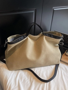 Large khaki canvas tote bag with black trim and striped lining for daily use