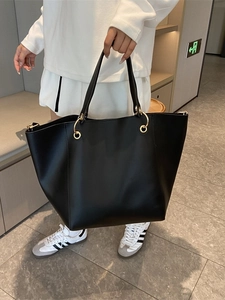 Classic black leather tote bag with stylish gold ring handles and large capacity