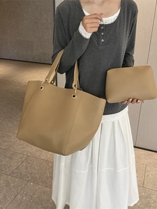 Minimalist earth-tone bucket bag set with tote and clutch shown on model