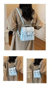 Detail of light blue checkered backpack with decorative bows and adjustable straps