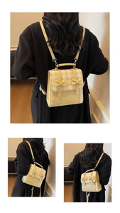 Macro shot showing yellow plaid pattern and cute 3D bows on a mini PU leather backpack