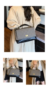 Grey black quilted shoulder bag with chain strap and top handle for women commuting.