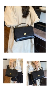 Detailed view of women's black quilted shoulder bag with gold turn-lock and chain strap.
