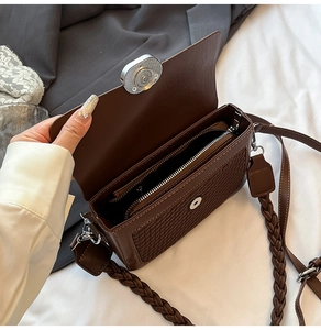 Detail showing the inner zip compartment and woven pattern on this brown shoulder bag