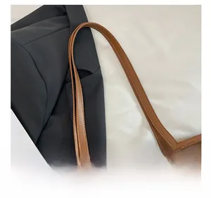 Detailed shot of comfortable brown litchi grain leather shoulder straps with gold buckles