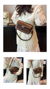 Detail of a brown crossbody bag with woven texture lid and elegant metallic oval buckle