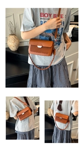 Detail view of brown square crossbody bag featuring woven texture and silver metal clasp