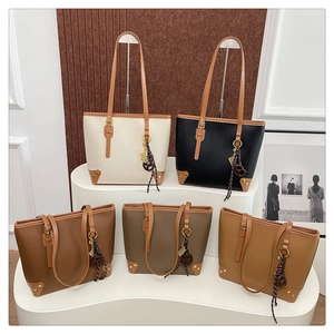 Multiple textured PU leather tote bags in five colors displayed on a stylish fashion stand