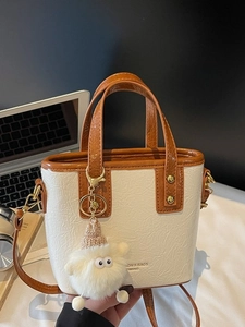 Fashionable mini bucket bag in cream and brown PU leather with cute sheep pendant