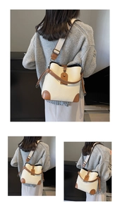 Macro view of cream bucket bag with brown trim and stylish lychee grain texture