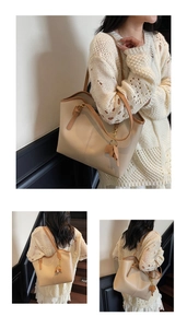 Detail of beige tote bag with slim brown straps and a leather bow accessory