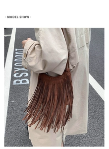 Outdoor street style model shot of a brown fringe crossbody bag with suede texture details