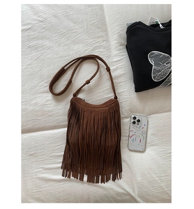Detail shot of vintage dark brown suede fringe bag with long adjustable strap