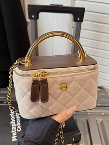 Beige quilted denim crossbody box bag with metal handle and golden floral chain strap