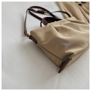 Casual nylon tote bag for women, waterproof crossbody shoulder bag with brown strap detail.