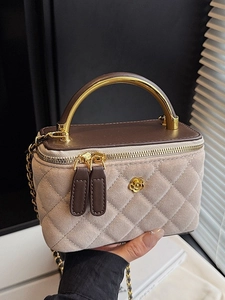 Beige quilted suede box bag with brown leather top handle and gold camellia hardware