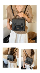 Detail view of a black faux leather mini backpack with gold hardware and flap closure