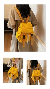 Detalle de mochila amarilla con hebillas de plástico negro y detalles de cordón rayado