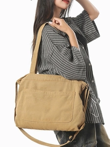 Vintage khaki canvas shoulder bag for women with large front pocket and long straps
