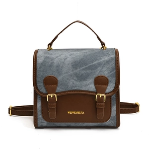 Vintage denim and brown leather patchwork backpack with gold buckle straps and handle