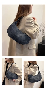 Detail of dark grey suede crescent hobo bag with silver zipper and slim shoulder strap