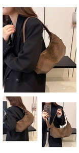 Detailed texture of dark brown suede half-moon shoulder bag with golden zipper closure