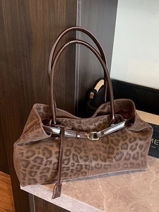 Brown leopard print large tote bag with gold metal accents on marble surface