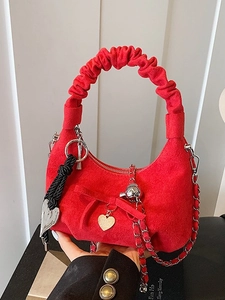 Red suede crescent moon bag with ruffled handle and metallic charms for women