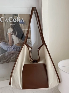 Contrast canvas tote bag with brown leather pocket and long shoulder straps for shopping