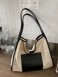 Contrast canvas tote bag with black leather pocket and shoulder straps for daily use