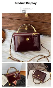 Detail of wine red patent leather mini bag with gold metal handle and chain strap