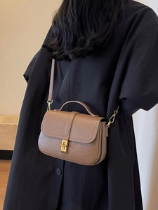 Retro dark brown pebbled leather crossbody bag with vintage gold hardware and flap closure