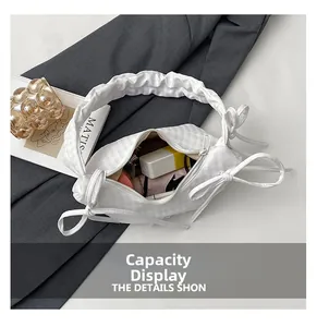 Interior view of white checkered shoulder bag showing storage for cosmetics and tissues