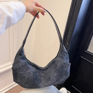 Deep grey textured hobo bag with vintage leather finish and silver zipper shown held in hand