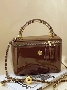 Brown glossy patent leather handbag with gold handle and floral logo crossbody bag