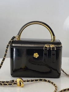 Chic black patent leather vanity bag with golden camellia logo and chain strap