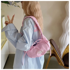 Pink checkered pleated crescent bag featuring side bows and soft padded shoulder strap