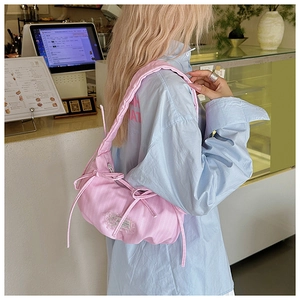 Pink pleated cloud crossbody bag with side bow detail and textured polyester fabric