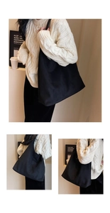 Minimalist black tote bag styled with a beige sweater for casual everyday wear