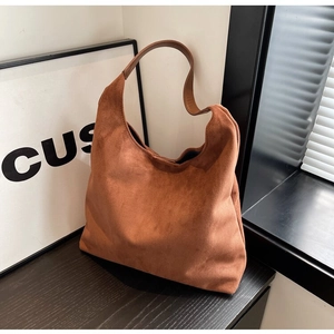 Detailed view of the brown faux suede material and stitching on the large hobo shoulder bag