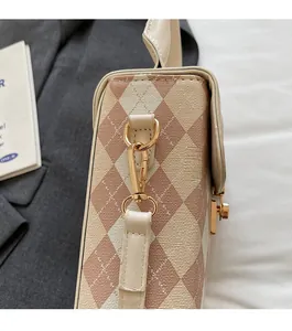 Close-up of vintage quilted mini bag with glossy gold metal hardware and textured fabric