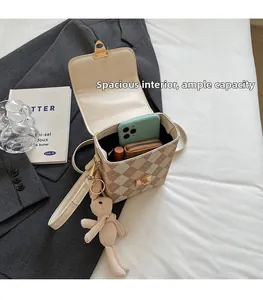 Detailed interior of the plaid box crossbody bag showing spacious storage capacity