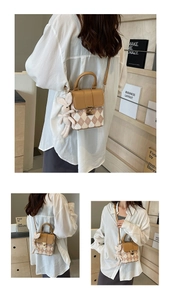 Close-up of quilted mini crossbody bag with a brown flap and cute white rabbit pendant